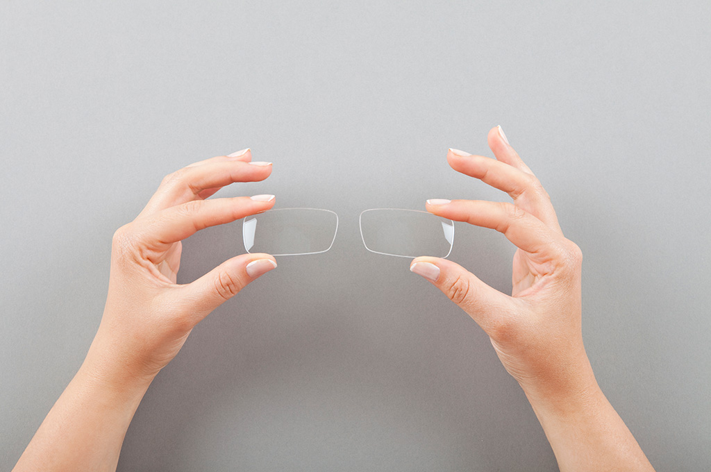 Person holding lenses up at eye level